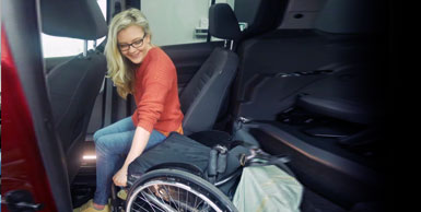 woman transferring from passenger seat to driver seat